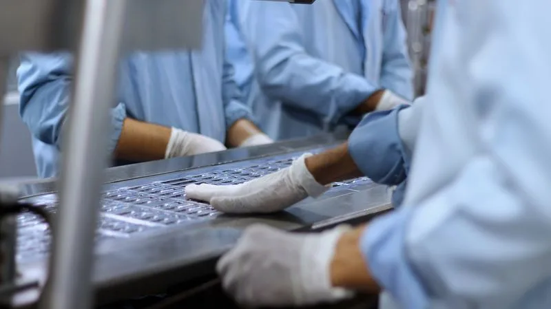Technicians inspecting tablets on a pharmaceutical production line